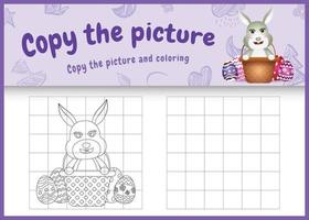 copie o jogo de crianças de imagem e página para colorir com tema de Páscoa com um coelho fofo no ovo de balde vetor