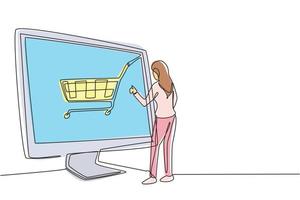 desenho de uma linha jovem mulher fazendo compras on-line por meio de uma tela gigante de computador com um carrinho de compras dentro. estilo de vida digital, conceito de consumismo. linha contínua desenhar design gráfico ilustração vetorial vetor