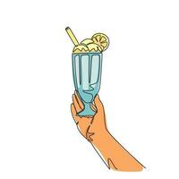 uma única mão de desenho de linha segura um copo grande com um milk-shake com chantilly, com um canudo e uma fatia de laranja. bebida doce. ilustração em vetor gráfico de desenho de linha contínua moderna