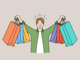 feliz jovem homem segurando compras saco comprando em vendas. sorridente cara mostrar numerosos parcelas compra coisas em promoção. consumismo e shopaholic. vetor ilustração.