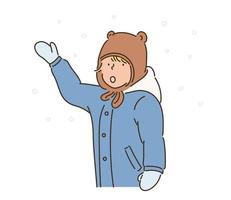 um menino com um chapéu de urso fofo está tentando pegar neve. mão desenhada estilo ilustrações vetoriais. vetor