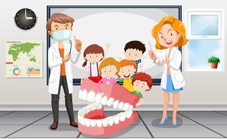 Dentistas e crianças em sala de aula vetor