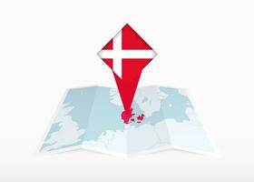 Dinamarca é retratado em uma guardada papel mapa e fixado localização marcador com bandeira do Dinamarca. vetor