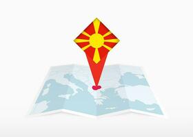 norte Macedônia é retratado em uma guardada papel mapa e fixado localização marcador com bandeira do norte macedônia. vetor