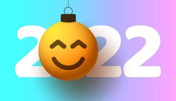 cartão de felicitações para o ano novo de 2022 com o rosto sorridente de emoji pendurado no fio como um brinquedo de Natal, bola ou bugiganga. ilustração em vetor conceito emoção de ano novo