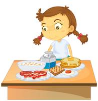 Uma menina tomando café da manhã no fundo branco