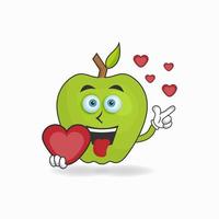 personagem do mascote da apple segurando um ícone de amor. ilustração vetorial vetor