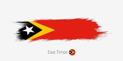 bandeira do leste timor, grunge abstrato escova acidente vascular encefálico em cinzento fundo. vetor