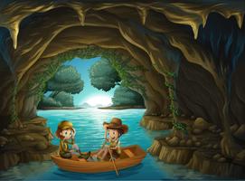 Uma caverna com duas crianças andando em um barco de madeira vetor