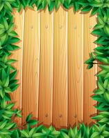 Design de fronteira com folhas verdes na parede de madeira vetor