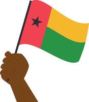 mão segurando e levantando a nacional bandeira do Guiné bissau vetor