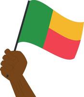 mão segurando e levantando a nacional bandeira do benin vetor