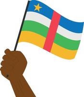 mão segurando e levantando a nacional bandeira do central africano república vetor