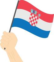 mão segurando e levantando a nacional bandeira do Croácia vetor