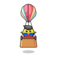mascote da bandeira da colômbia montando um balão de ar quente vetor