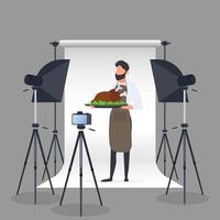 blogueiro de culinária. um homem com um avental de cozinha segura um frango frito em uma bandeja. câmera em um tripé, softbox. conceito de blog ou vlog culinário. vetor. vetor
