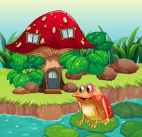Uma casa de cogumelo gigante perto do rio com um sapo vetor