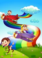 Um céu com um arco-íris e aviões com macacos vetor