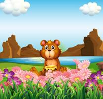 Um urso bonito perto das flores na margem do rio vetor