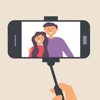 jovem casal tira fotos em um pau de selfie. fotógrafo vetor