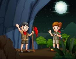 o escoteiro menino e menina caminhando na caverna