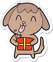 adesivo de um cachorro bonito dos desenhos animados com presente de natal vetor
