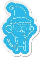 adesivo de desenho animado de um macaco buzinando usando chapéu de papai noel vetor