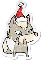 desenho de adesivo tímido e angustiado de um lobo usando chapéu de papai noel vetor