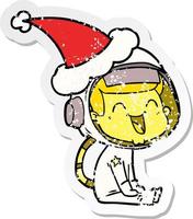 feliz desenho de adesivo angustiado de um astronauta usando chapéu de papai noel vetor
