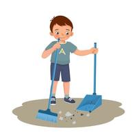 menino bonitinho varrendo o chão com vassoura e colher na sala de estar fazendo tarefas domésticas de rotina diária vetor