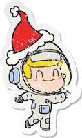 feliz desenho de adesivo angustiado de um homem astronauta usando chapéu de papai noel vetor