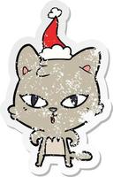 desenho de adesivo angustiado de um gato usando chapéu de papai noel vetor