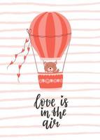 um cartão de dia dos namorados com um urso fofo voando em um balão e uma frase manuscrita - o amor está no ar. um símbolo de amor, romance. ilustração em vetor plana de cor de fundo de textura listrada.