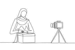 único desenho de linha de beleza árabe feminino show unboxing recebido pacote ao vivo em casa. mulher vlogger unboxing produto, gravação de revisão na câmera. ilustração em vetor design de desenho de linha contínua