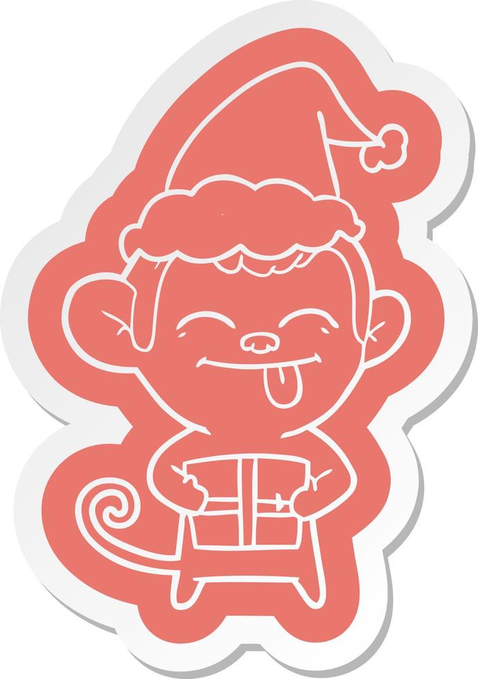 adesivo divertente cartone animato di una scimmia con regalo di Natale che indossa il cappello di Babbo Natale vettore