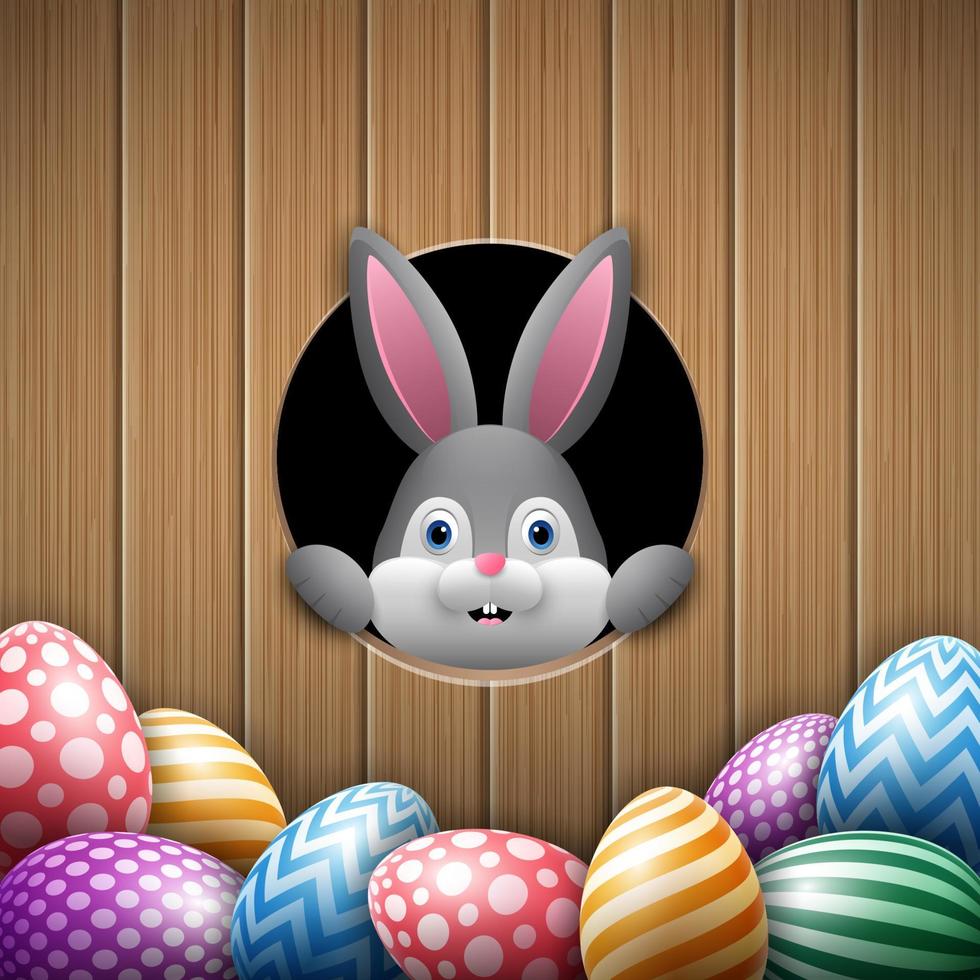 carino Pasqua coniglietto sbirciando su di un' buco con colorato uova vettore