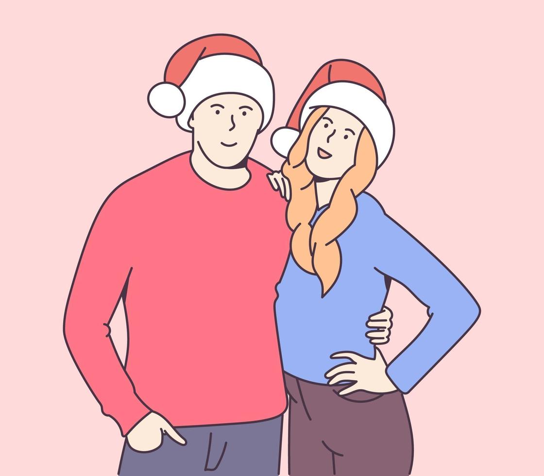 natale, regalo, concetto di capodanno. giovane coppia sorridente felice in cappelli di Natale che abbraccia. celebrazione tradizionale. vettore