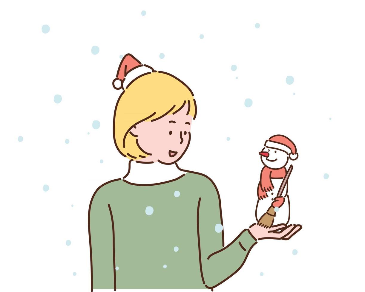 una ragazza sta guardando con un piccolo pupazzo di neve tra le mani. entrambi indossano cappelli di Babbo Natale. illustrazioni di disegno vettoriale stile disegnato a mano.