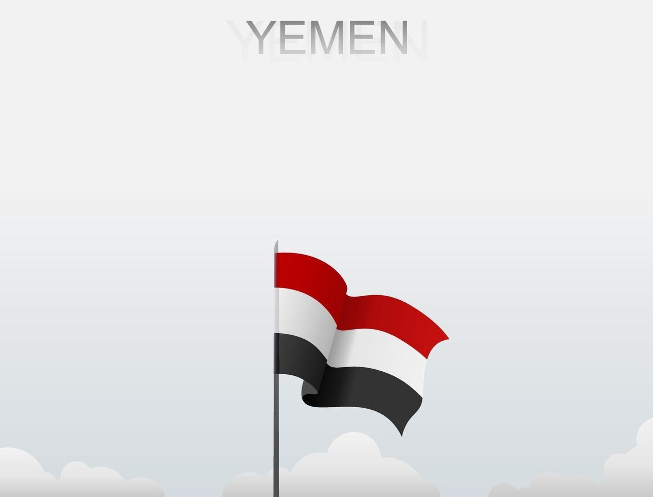 la bandiera dello Yemen sta sventolando su un palo che si erge alto sotto il cielo bianco vettore