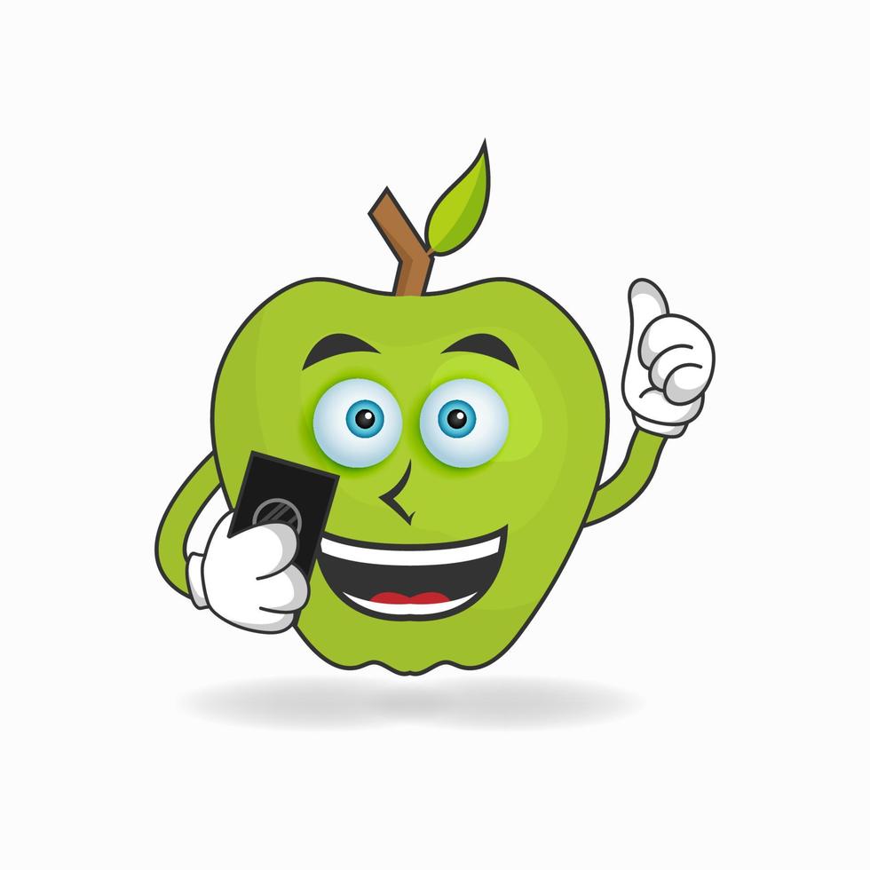 personaggio mascotte della mela che tiene in mano un cellulare. illustrazione vettoriale