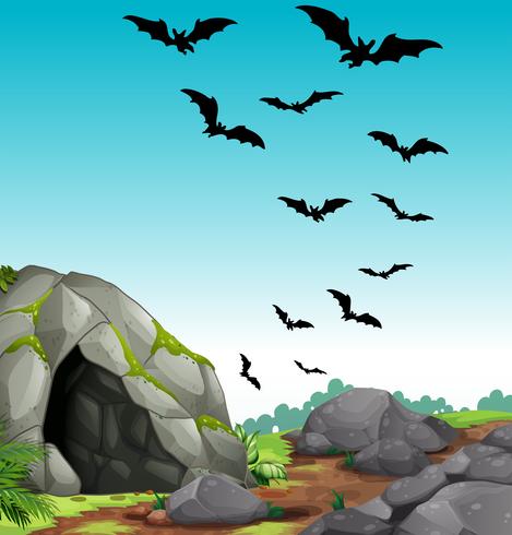 I pipistrelli volano fuori dalla grotta vettore