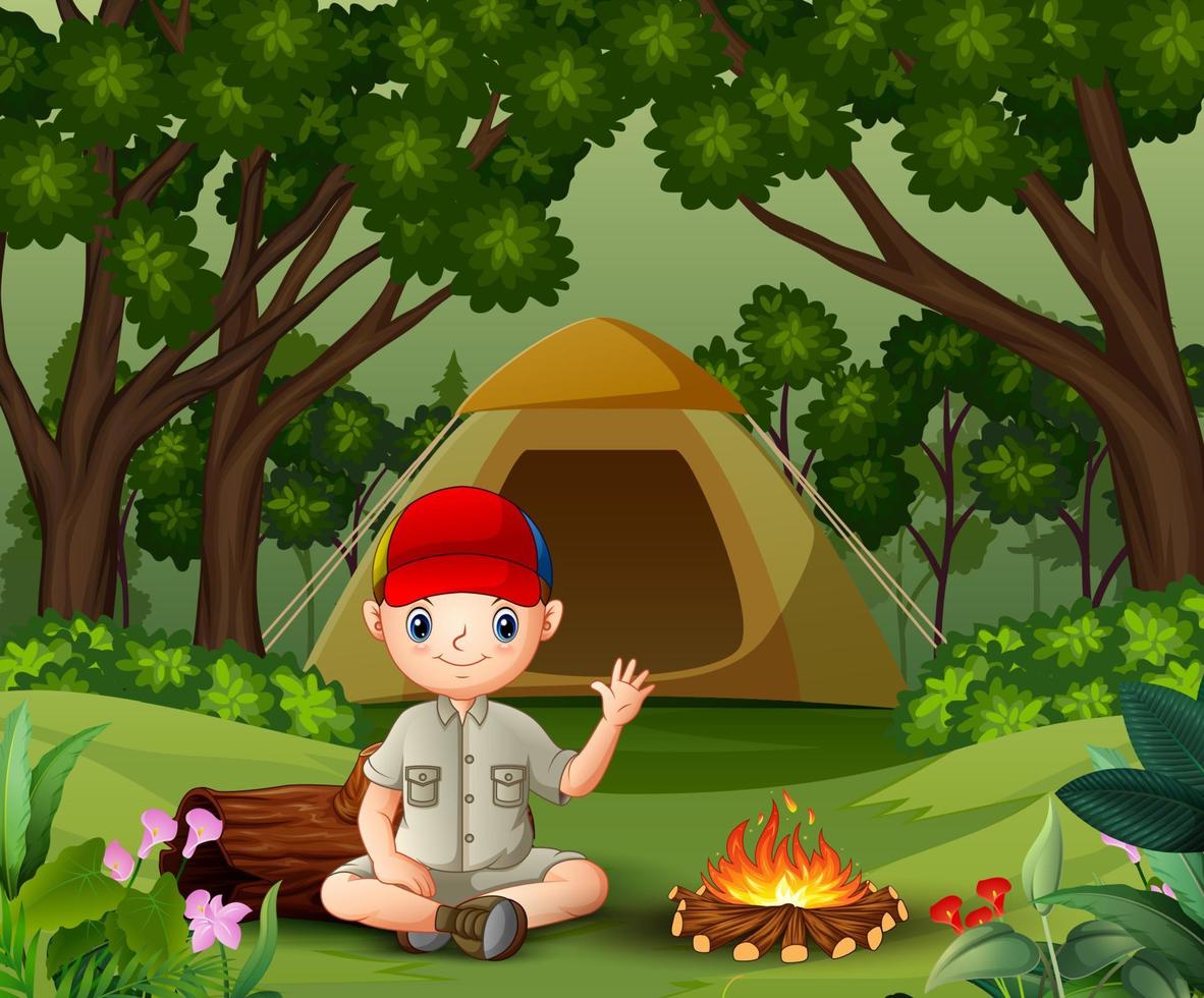 boy scout seduto vicino al fuoco vettore