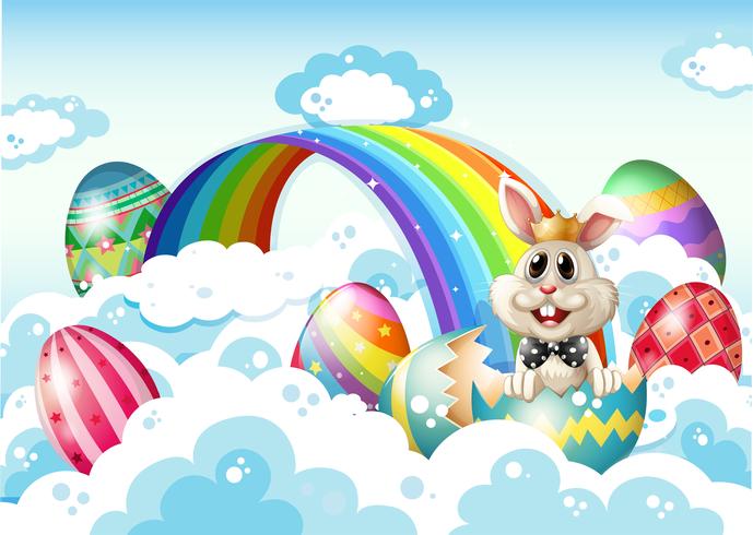 Un re coniglio nel cielo con le uova di Pasqua vicino all&#39;arcobaleno vettore