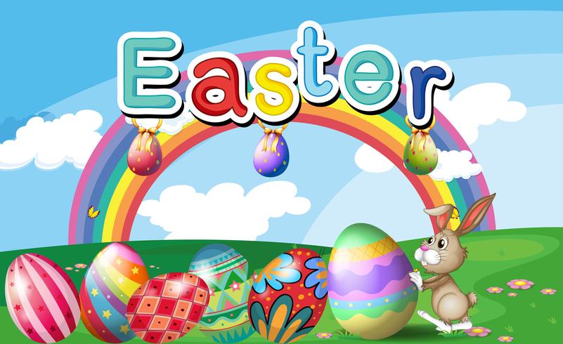 Una collina con uova di Pasqua, un arcobaleno e un coniglio vettore