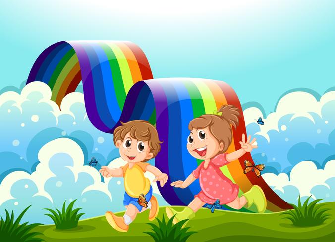 Bambini felici che giocano in cima alla collina con un arcobaleno vettore