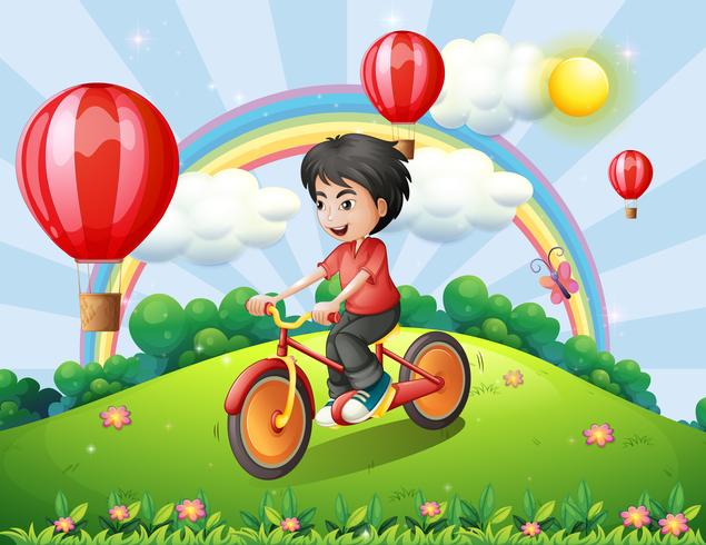 Un ragazzo in bicicletta in cima alla collina con un arcobaleno e palloncini galleggianti vettore