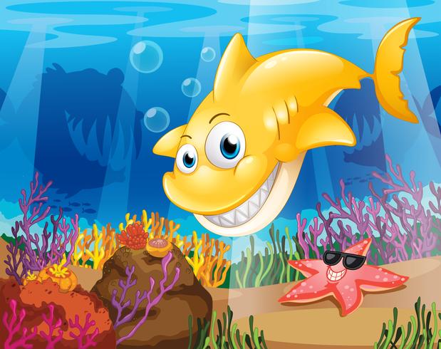 Uno squalo giallo sotto il mare con stelle marine e coralli vettore