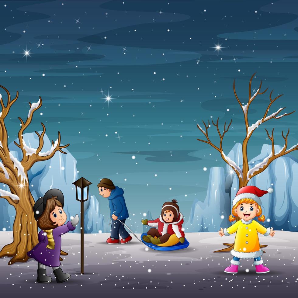 bambini felici che giocano nel paesaggio invernale vettore