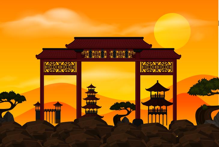 Cancello cinese sulla roccia al tramonto vettore