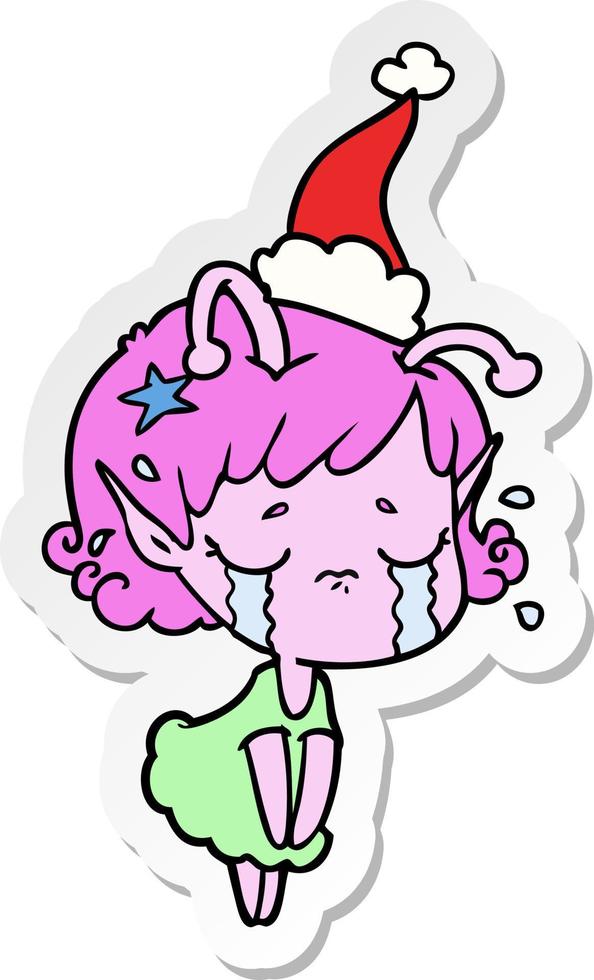 adesivo cartone animato di una ragazza aliena piangente che indossa il cappello di Babbo Natale vettore